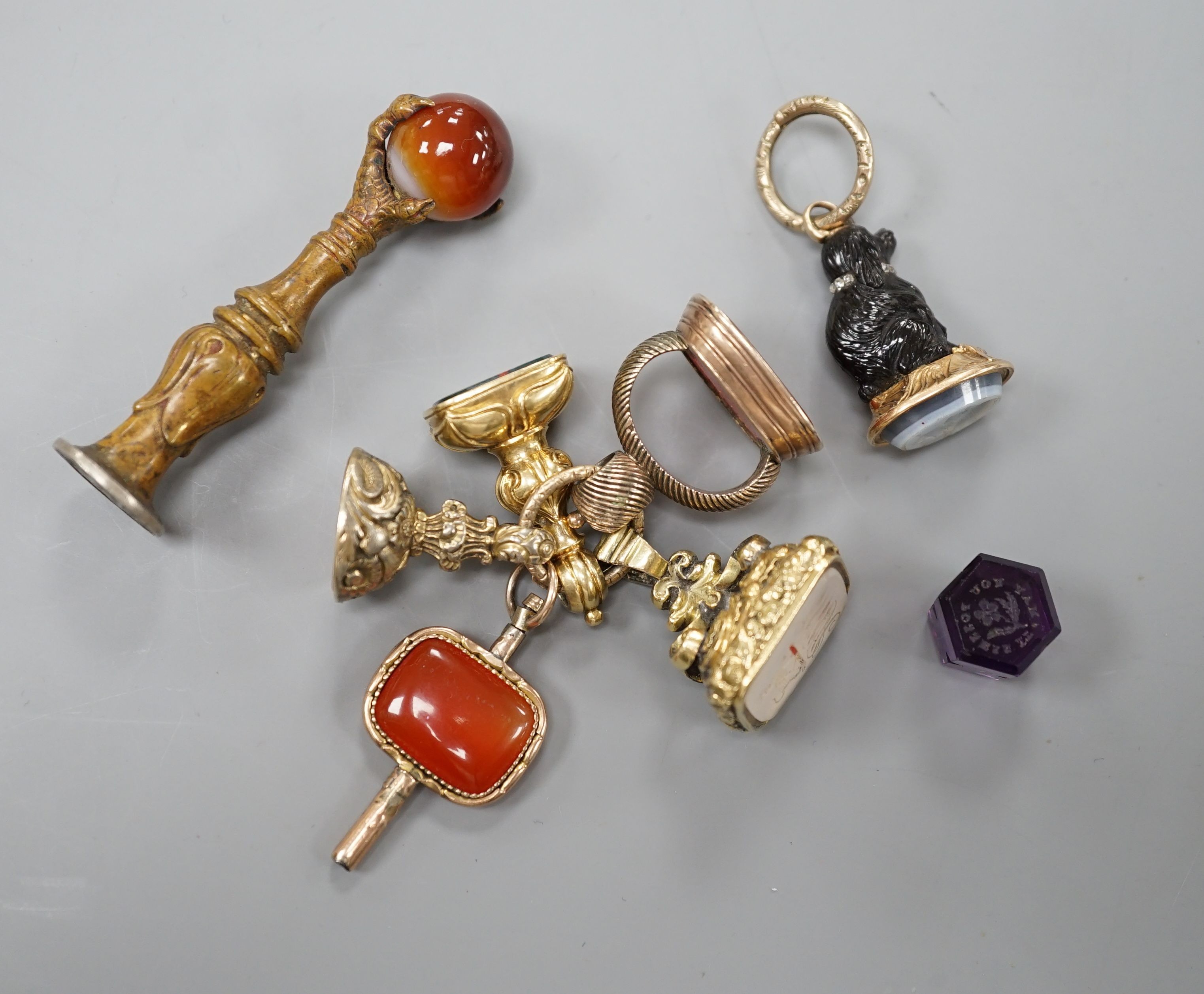 Eight assorted 19th century and later fob seals including a rose diamond set black glass dog with Roman head intaglio, 3cm, a gold overlaid and watch key